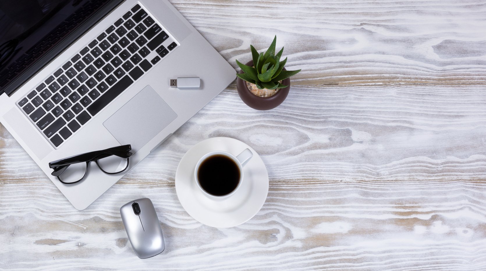 Coffee and Laptop on Wooden Desk